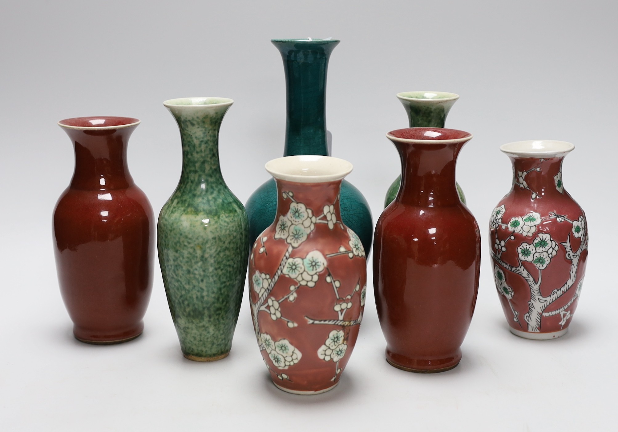 A pair of Chinese sang de boeuf vases, another pair of Chinese mottled green bottles vases, two pink ground prunus vases and a turquoise glaze bottle vase, tallest 23cm (7)